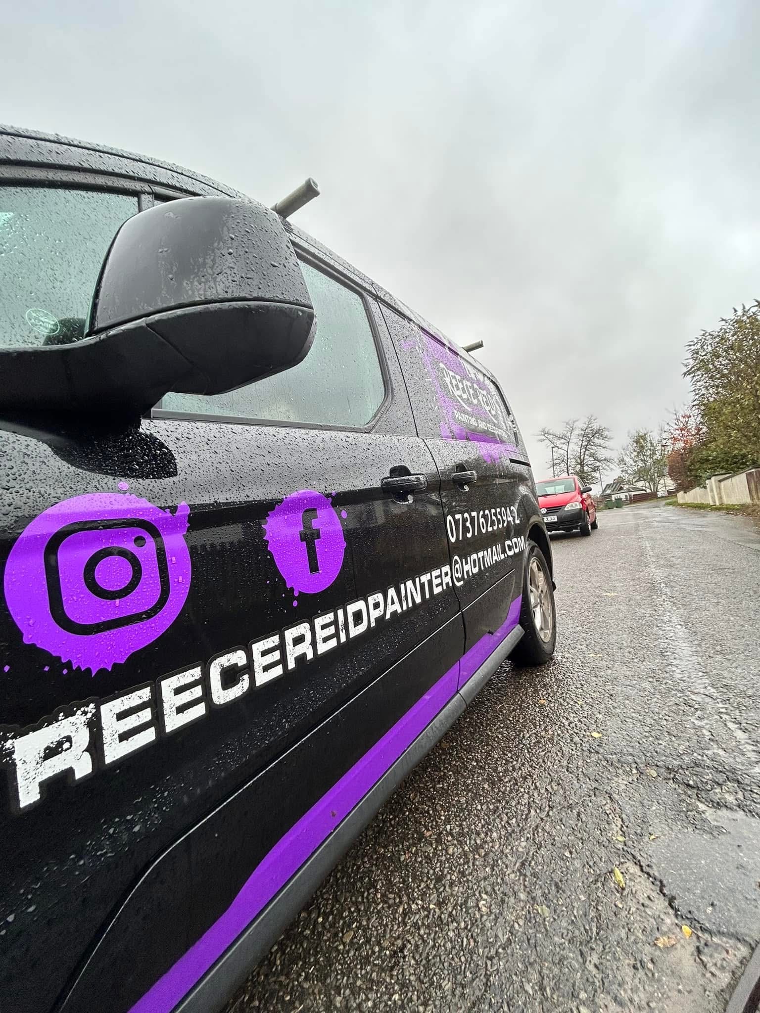 Close side view of the Reece Reid van graphics and contact details